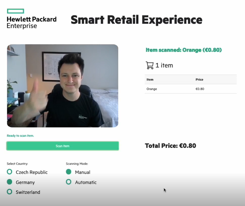 This pictures shows the end result of the ML model and webcam simplifying a retail checkout process by identifying and placing the cost of an orange in the customer's virtual basket. 